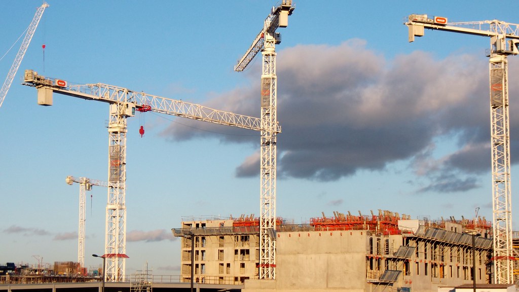 Construction cranes on a commercial building project site